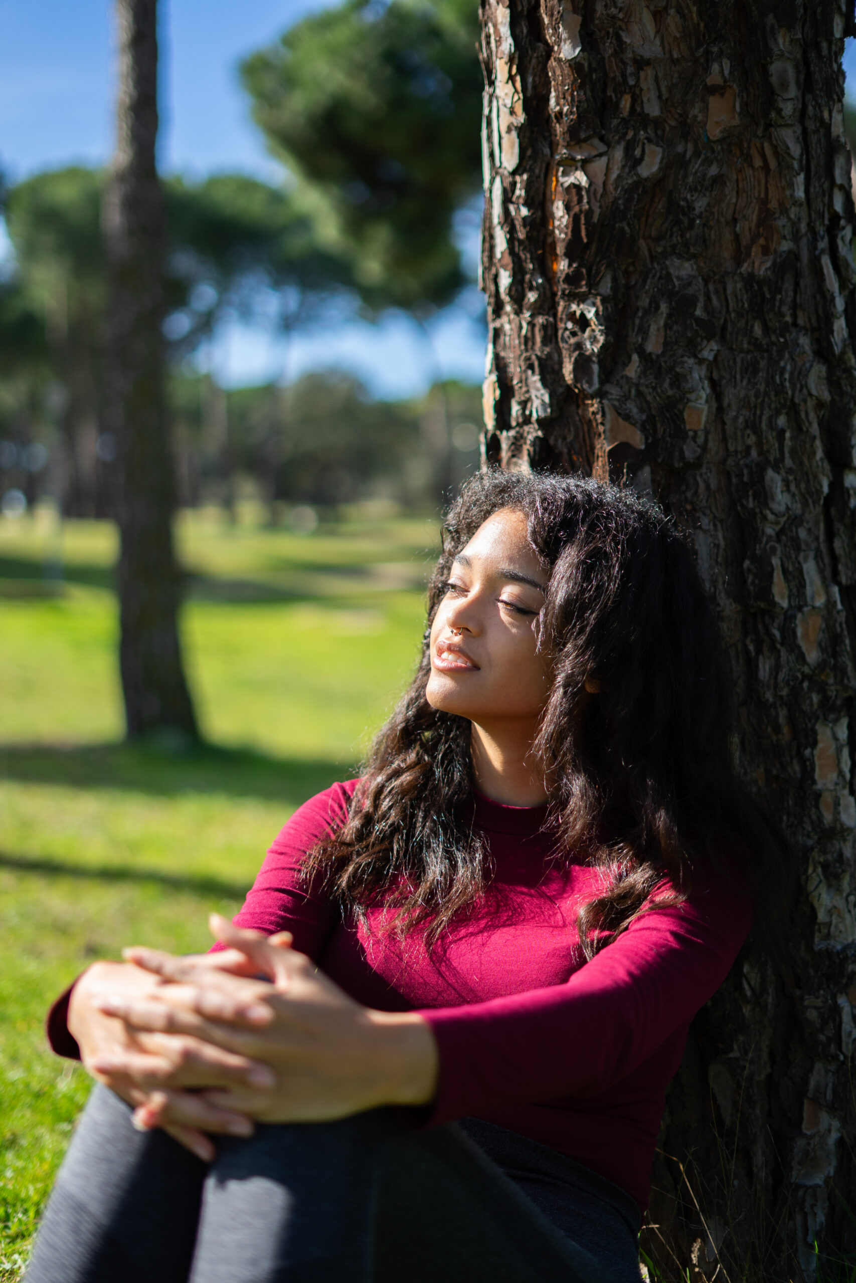 Young latin woman relaxing in the park, enjoying nature's embrace