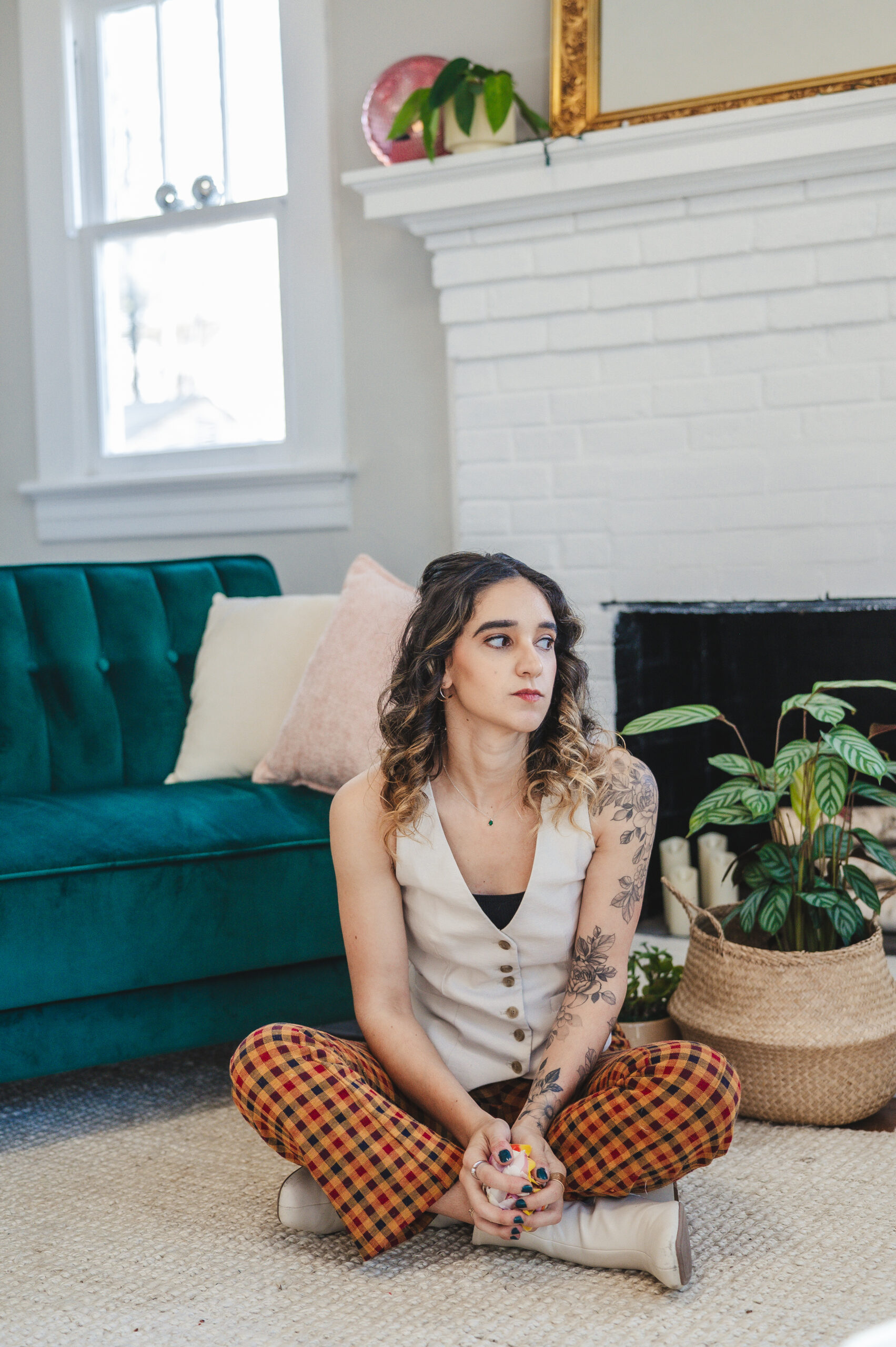 Young woman sitting on the living room floor looking anxious